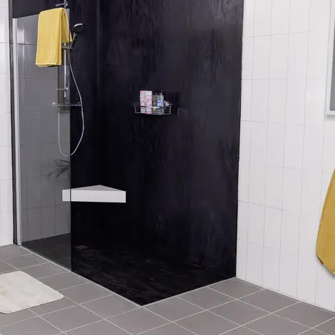 Modern shower with seat and black back wall